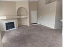 The living room has neutral walls, carpeting and a fireplace with an alcove above at 900 Heavenly Hills Ct # 219, Las Vegas, NV 89145