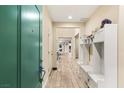 Entryway boasting built-in storage, seating and light wood-look flooring at 9096 Becket Ranch Ct, Las Vegas, NV 89113
