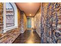 Inviting entryway with decorative iron door, stone accent wall, and tile flooring at 9096 Becket Ranch Ct, Las Vegas, NV 89113