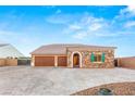 Charming single-story home with stone accents, decorative shutters, three-car garage and wide driveway at 9096 Becket Ranch Ct, Las Vegas, NV 89113