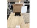 Showcasing kitchen material samples including cabinets, paint, quartz countertop, vinyl plank flooring and carpet at 10032 Indy Rey Ct, Las Vegas, NV 89148