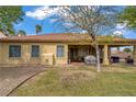 Spacious backyard featuring a covered patio, lush green grass, desert landscaping, and a cozy outdoor dining area at 10201 Los Padres Pl, Las Vegas, NV 89134