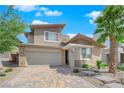 A captivating two-story home showcasing desert landscaping, stone accents and a brick driveway at 10254 Kesington Dr, Las Vegas, NV 89135