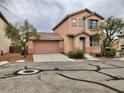 Charming two-story home featuring a tile roof, neat landscaping, and an attached two-car garage at 10719 Tottenham Ave, Las Vegas, NV 89135