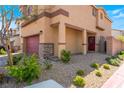 Charming two-story home with a two car garage, stone veneer and manicured landscaping at 10987 Kingston Fields Ave, Las Vegas, NV 89166