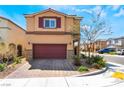 Charming two-story home with a two car garage, brick driveway and manicured landscaping at 10987 Kingston Fields Ave, Las Vegas, NV 89166