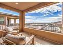 Relaxing balcony showcasing comfortable seating and beautiful views of the city skyline at 12401 Ferry Glide Ave, Las Vegas, NV 89138