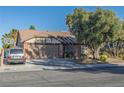 Charming single-story home featuring a two-car garage, a car parked in the driveway, and mature landscaping at 146 Cascade Dr, Henderson, NV 89074