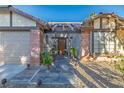 Inviting front entrance with a security gate, brick accents, and decorative landscaping at 146 Cascade Dr, Henderson, NV 89074