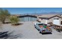 View of outbuildings showing a large shop and an additional storage unit or garage space at 1540 Labrador St, Pahrump, NV 89048