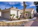 Single-story home with desert landscaping and a two-car garage at 1709 Autumn Rust Dr, Las Vegas, NV 89119