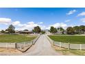 Long driveway leading to residences, surrounded by sprawling green lawns and white fencing at 1988 N Moapa Valley Blvd, Logandale, NV 89021