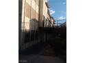 Exterior side view of a two-story condo featuring a secure gated patio at 2080 Karen Ave # B-41, Las Vegas, NV 89169