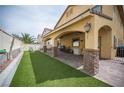 A spacious backyard featuring a covered patio and an artificial grass area at 4440 Pacific Crest Ave, Las Vegas, NV 89115