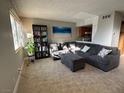 Bright living room showcasing a cozy gray sofa and decorative touches with easy access to kitchen at 4770 Topaz St # 73, Las Vegas, NV 89121