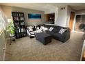 Inviting living room featuring a comfortable gray sectional sofa and a stylish bookcase at 4770 Topaz St # 73, Las Vegas, NV 89121