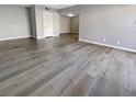 Spacious living room showcasing modern gray floors and fresh paint at 5286 River Glen Dr # 421, Las Vegas, NV 89103