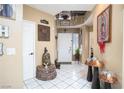 Bright foyer with tile flooring, decorative accents, and a view of the staircase at 5325 Sandstone Dr, Las Vegas, NV 89142
