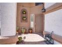 Welcoming front entrance with decorative plants and a wrought iron security door at 5325 Sandstone Dr, Las Vegas, NV 89142