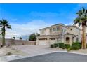 Exterior view of a charming two-story home boasting desert landscaping and a three-car garage at 5588 Holcomb Bridge Ct, Las Vegas, NV 89149