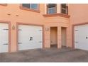 Property with three garage doors each with carriage hardware and a covered entry at 6 Via Vasari # 105, Henderson, NV 89011