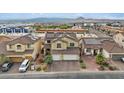 Aerial view of the home featuring a two-car garage, desert landscaping and a solar panel system at 640 Finch Island Ave, Henderson, NV 89015