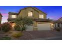 Inviting two-story home with lush landscaping, mature tree, and attached two-car garage at 640 Finch Island Ave, Henderson, NV 89015