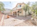 Private backyard featuring a covered patio and brick paved walkway at 6630 Cave Rock Ave, Las Vegas, NV 89110