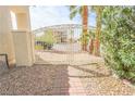 Ornate wrought iron gate and charming brick pathway leading to the property entrance at 6630 Cave Rock Ave, Las Vegas, NV 89110
