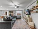 Bright living room with a large comfortable couch, hardwood floors, and access to outdoor area at 817 Great Sky Ct, North Las Vegas, NV 89084