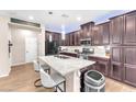 Kitchen island with granite countertop, stainless steel sink, and seating for casual dining at 8507 Insignia Ave # 102, Las Vegas, NV 89178