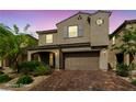 Attractive two-story home with a two car garage, landscaped front yard, and stylish architectural details at 8675 Principato St, Las Vegas, NV 89166
