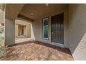 Inviting covered front porch with brick pavers and a view of the front door at 8675 Principato St, Las Vegas, NV 89166