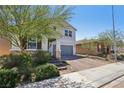 View of a two-story home with brick driveway and desert landscaping at 9625 W Meranto Ave, Las Vegas, NV 89178
