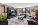 Spacious living room with a large entertainment center and plush carpet at 9625 W Meranto Ave, Las Vegas, NV 89178
