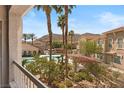 Balcony view showcasing a beautiful pool, palm trees, mountain views, and surrounding community at 10550 W Alexander Rd # 2017, Las Vegas, NV 89129