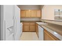 Well-maintained kitchen featuring light wood cabinets and white appliances at 10550 W Alexander Rd # 2017, Las Vegas, NV 89129