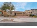 Charming house with a three-car garage, desert landscaping, and a welcoming entrance at 1273 Olivia Parkway Pkwy, Henderson, NV 89011