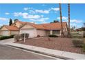 Single-story home with a two-car garage, desert landscaping and well-manicured bushes, topped by a red tile roof at 1335 Heather Oaks Way, North Las Vegas, NV 89031