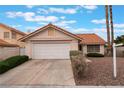 Single-story home with a two-car garage, desert landscaping and well-manicured bushes, topped by a red tile roof at 1335 Heather Oaks Way, North Las Vegas, NV 89031