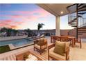 Inviting outdoor patio area featuring comfortable seating, dining space, and a spiral staircase leading to upper level at 144 Tre Pietre St, Henderson, NV 89011