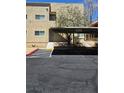 View of home exterior showcasing stucco facade, carport and walkway at 1832 N Decatur Blvd # 104, Las Vegas, NV 89108