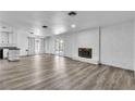 Open-concept living room featuring a decorative fireplace and laminate flooring at 2204 Monterey Ave, Las Vegas, NV 89104