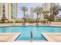 Relaxing swimming pool surrounded by lounge chairs and lush landscaping at 2747 Paradise Rd # 2606, Las Vegas, NV 89109
