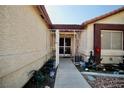 Inviting gated entrance with a paved walkway, garden pots, and decorative flowers at 2905 Gentilly Ln, Las Vegas, NV 89108