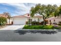 Charming single-story home with a well-maintained lawn, mature tree, and a two-car garage at 3561 Cherbourg Ave, Las Vegas, NV 89141