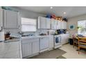 Functional kitchen featuring white appliances, tile countertops, and ample cabinet space at 3561 Cherbourg Ave, Las Vegas, NV 89141