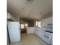 Bright kitchen with white cabinets, appliances and tile flooring at 3561 Cherbourg Ave, Las Vegas, NV 89141