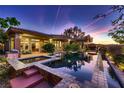 Inviting pool area with custom tile work, water feature, and covered outdoor space at 4 Dry Brook Trl, Henderson, NV 89052