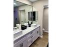 Modern bathroom with double vanity, undermount sinks, and sleek black hardware at 4083 Nook Way # A, Las Vegas, NV 89103
